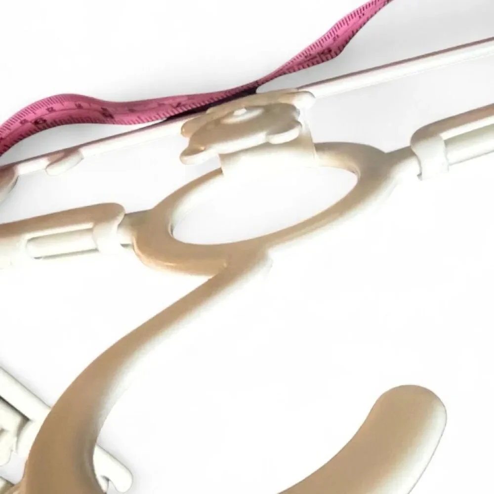 9 White plastic baby clothes hangers with bear design